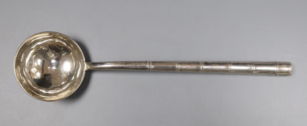 An early 20th century Chinese Export white metal ladle, with faux bamboo handle, Wing Nam & Co, 18.9cm, 40 grams.